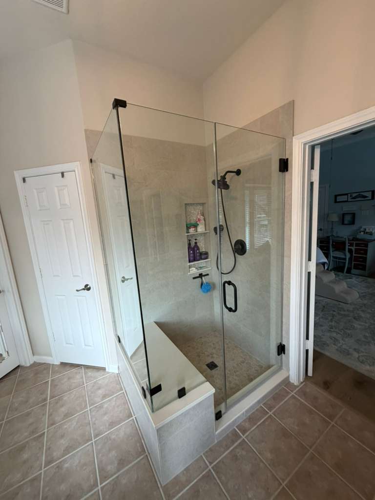 Frameless shower with matte black hardware and interior bench